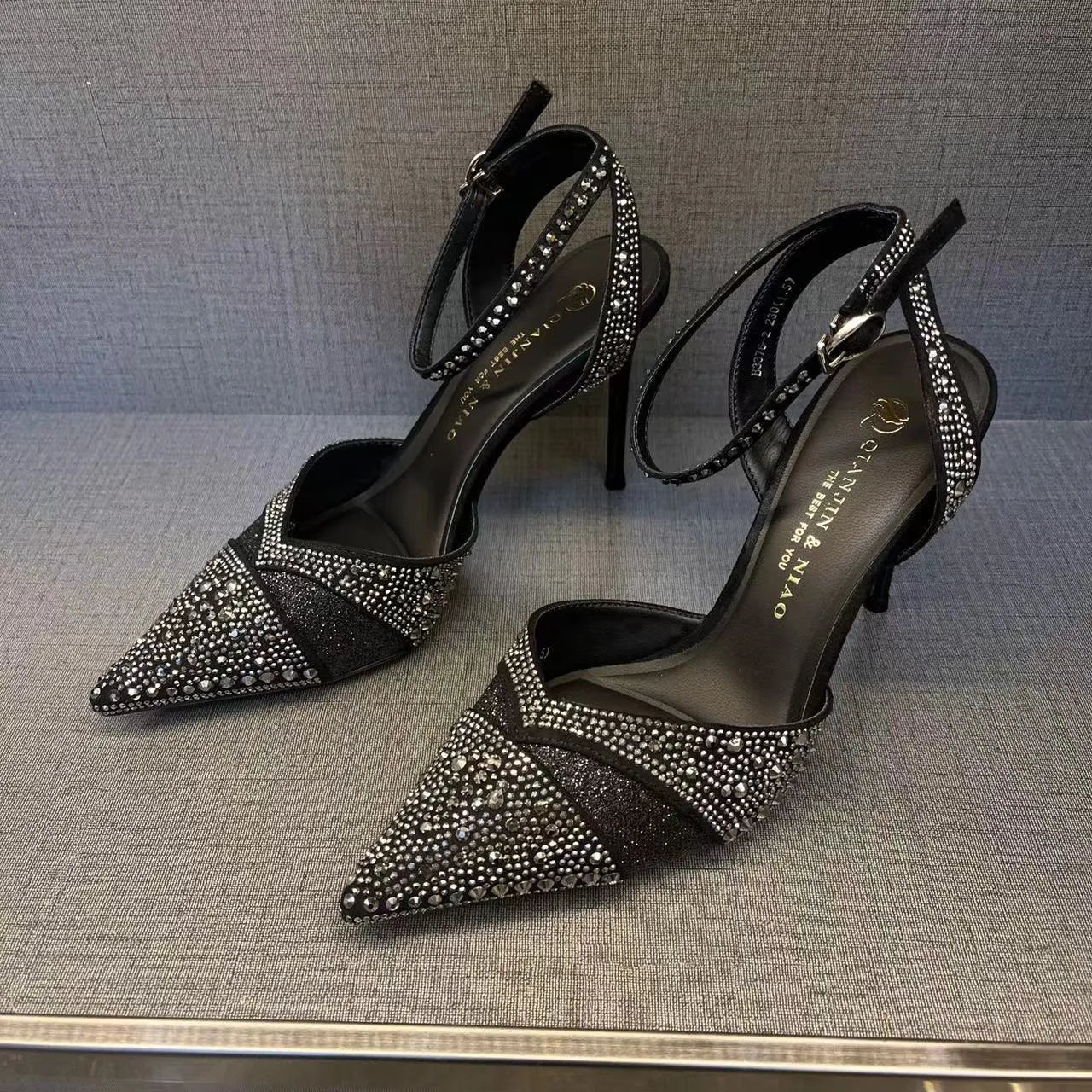 Women's silver and black stiletto heels with red sole and hollow design, pointed toe formal shoes