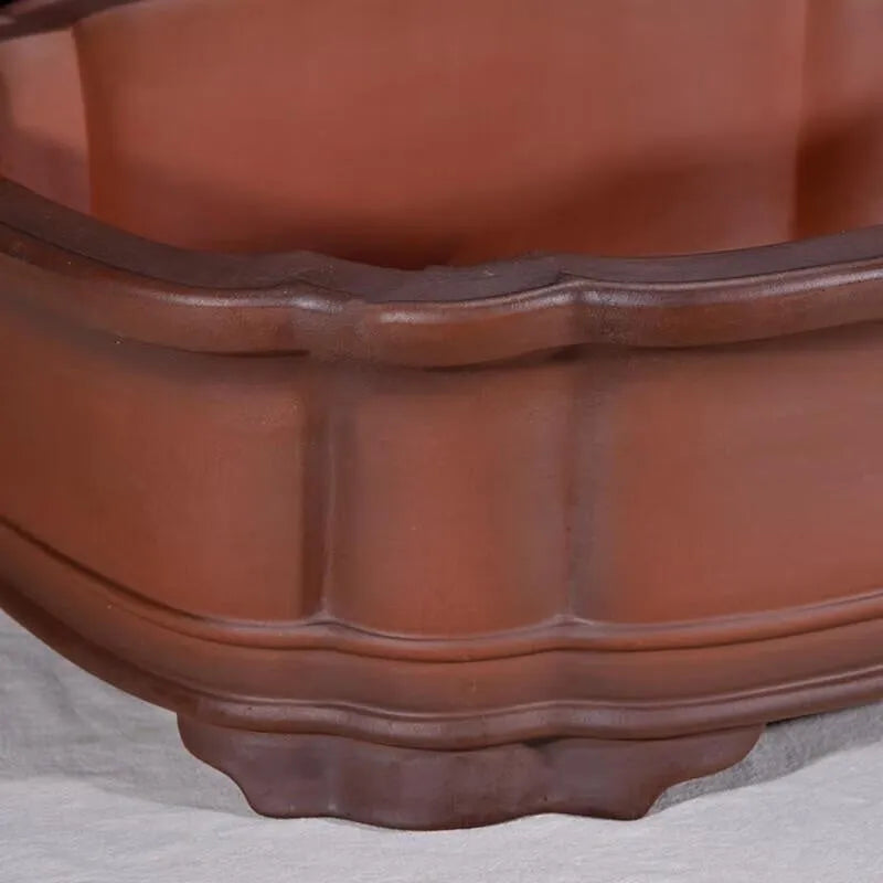 Large antique-finish Chinese purple clay flowerpot shaped like a tree stump with decorative carvings.