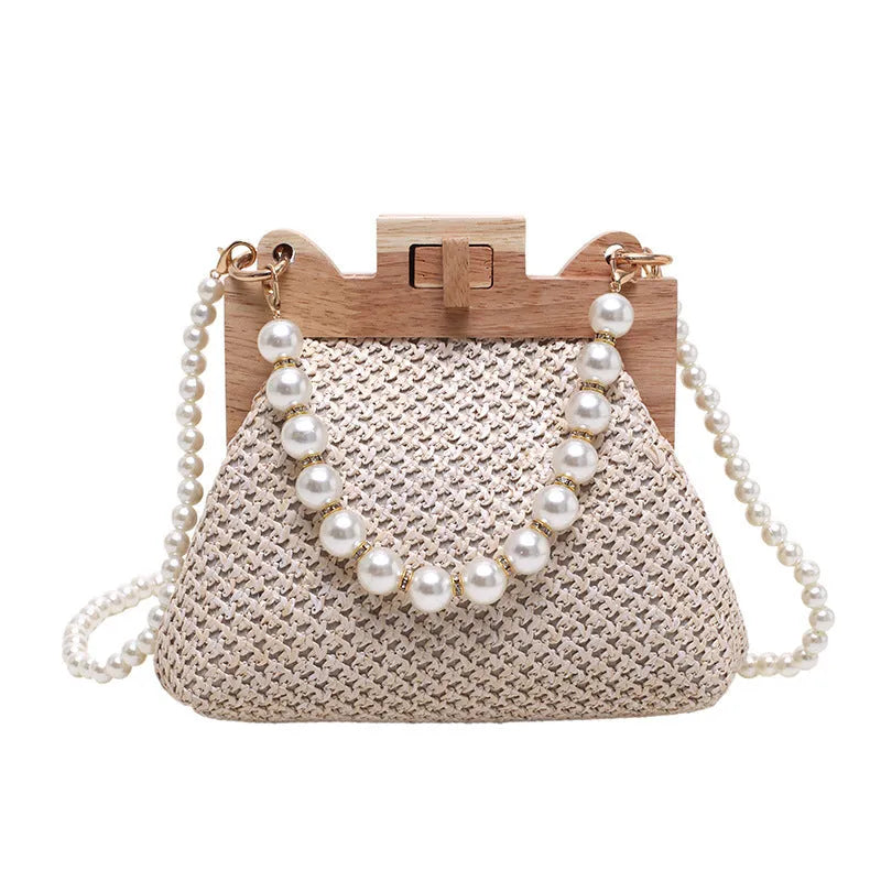 Women's woven straw shoulder bag with pearl chain detail in beige colour, showing interior organiser pockets.
