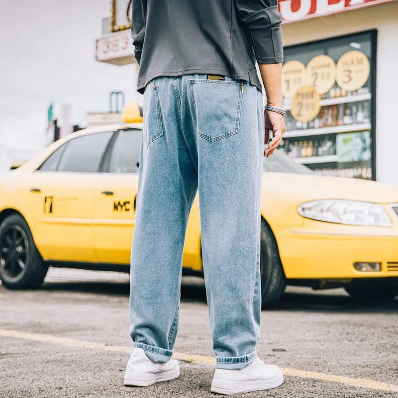 Men's loose straight cotton jeans in dark blue, light blue, and gray with mid-waist zipper fly