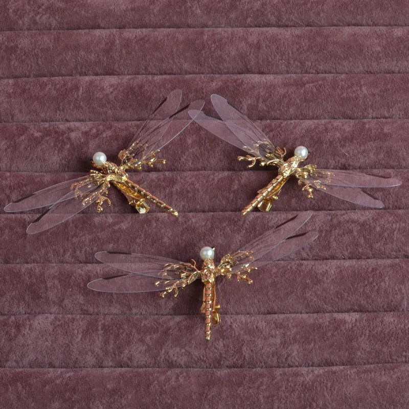 Golden dragonfly-shaped metal alloy headdress with a side clip for hair.