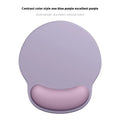 Silicone mouse mat with attached gel wrist support in a gradient blue colour on a desk.