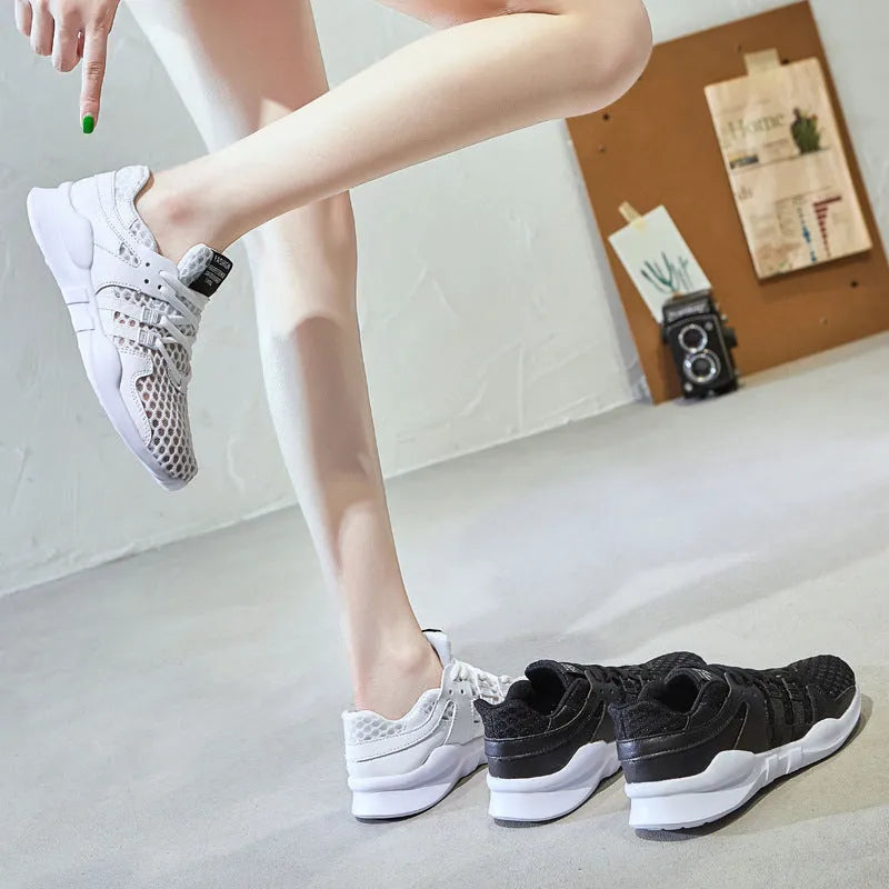 Side view of black hollow breathable mesh sneakers with flat EVA sole and round toe design