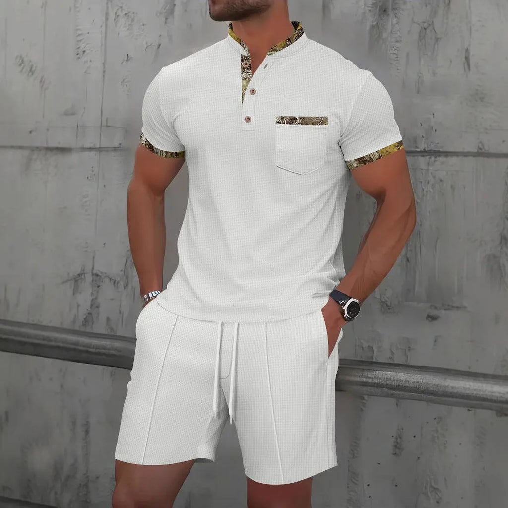Man wearing a grey waffle knit zip-up polo collar tracksuit with matching shorts for summer leisure.