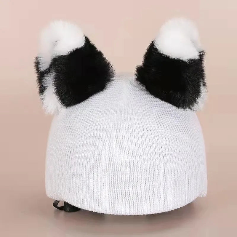A plush fabric cartoon character helmet hat cover with attached ears on a white background.
