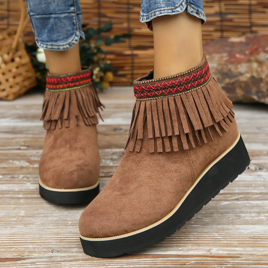 Womens dark brown suede wedge ankle boots with side zip and tassel detail on a thick rubber sole.