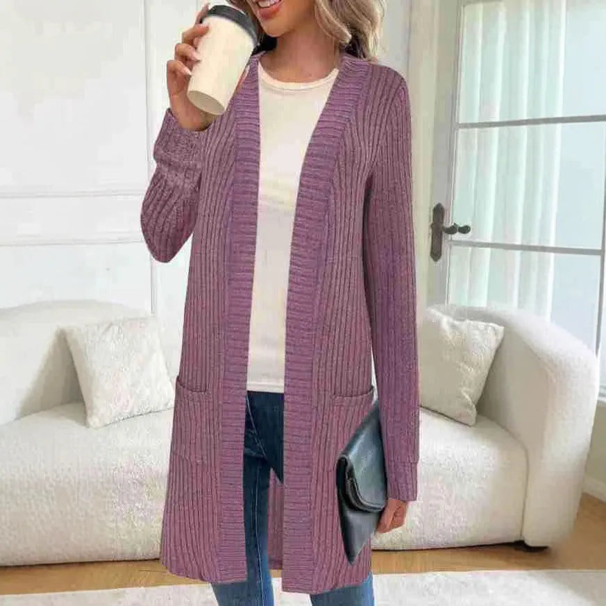 Long sleeve loose fit knitted cardigan jacket in black, shown with two front pockets.