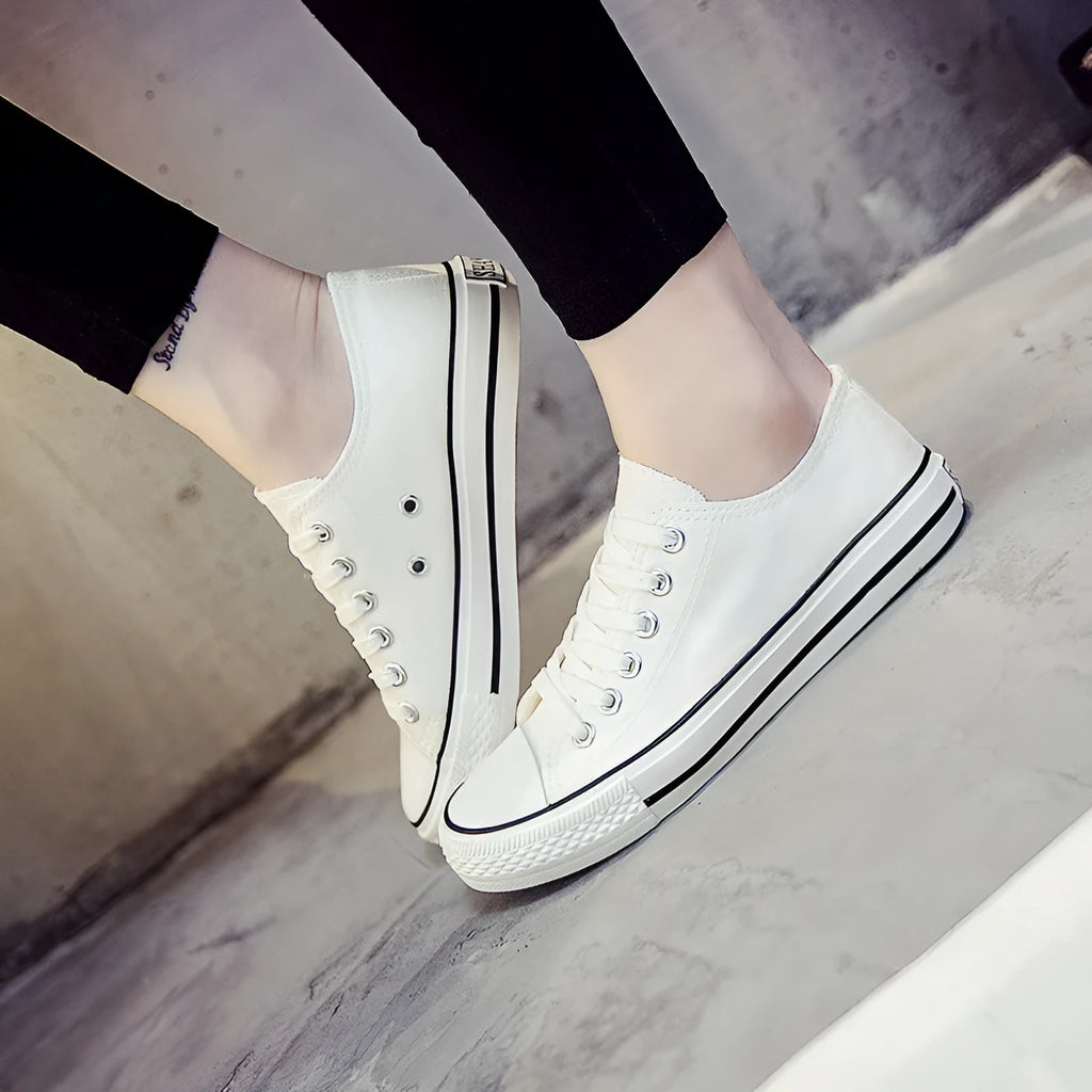 Solid colour women's casual canvas slip-on shoes on a white background, showing the simple design and canvas upper material.