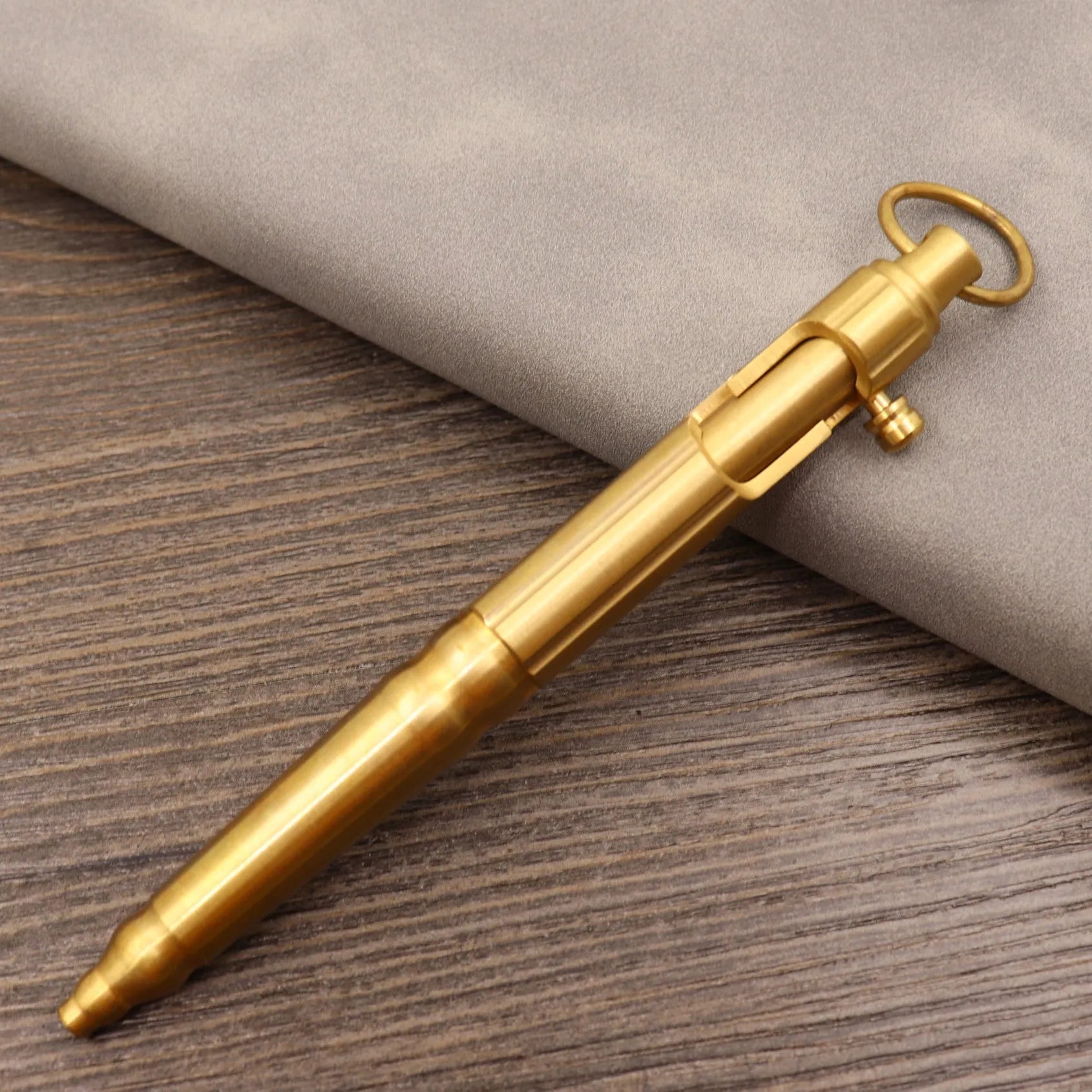 Retro brass tactical pen with bolt action mechanism in brushed natural finish