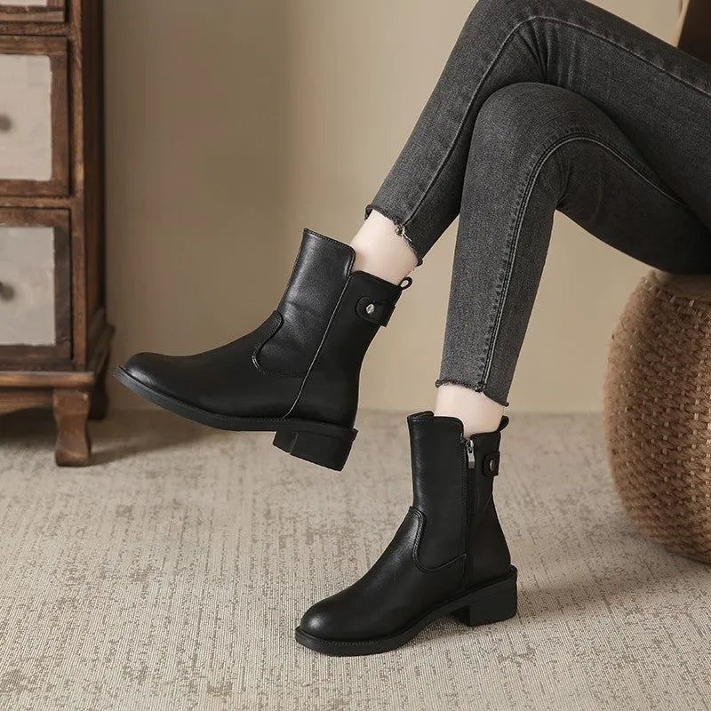 Black women's ankle boots with side zip and a low round toe.