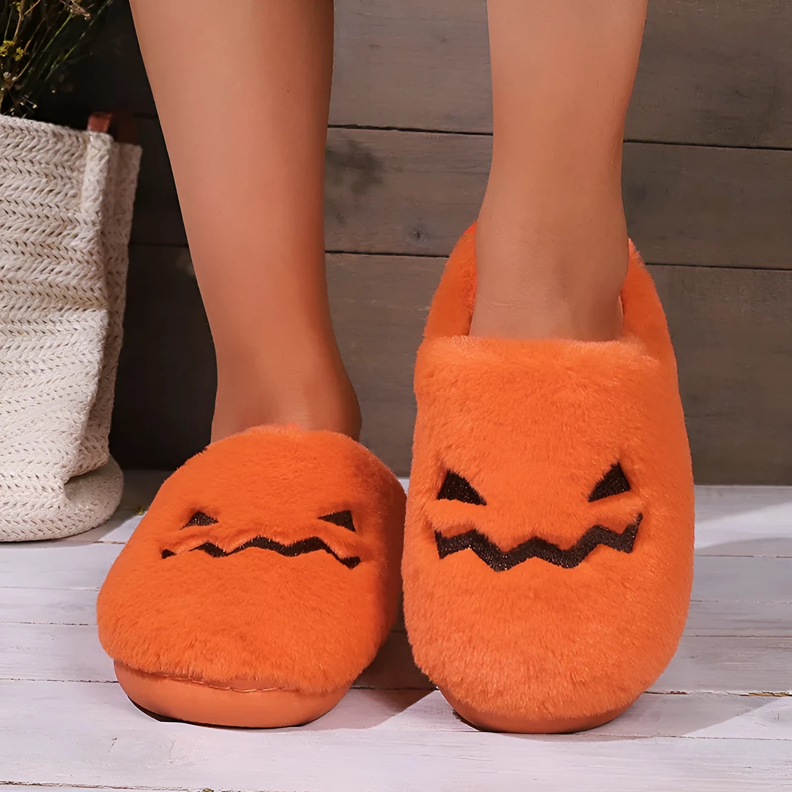 Orange women's pumpkin-themed plush slippers with a coral velvet upper and a flat non-slip sole.