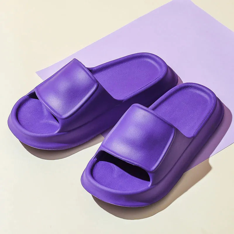 Thick-soled EVA flip-flop slippers in multiple colours on a bathroom floor, showing non-slip sole texture.