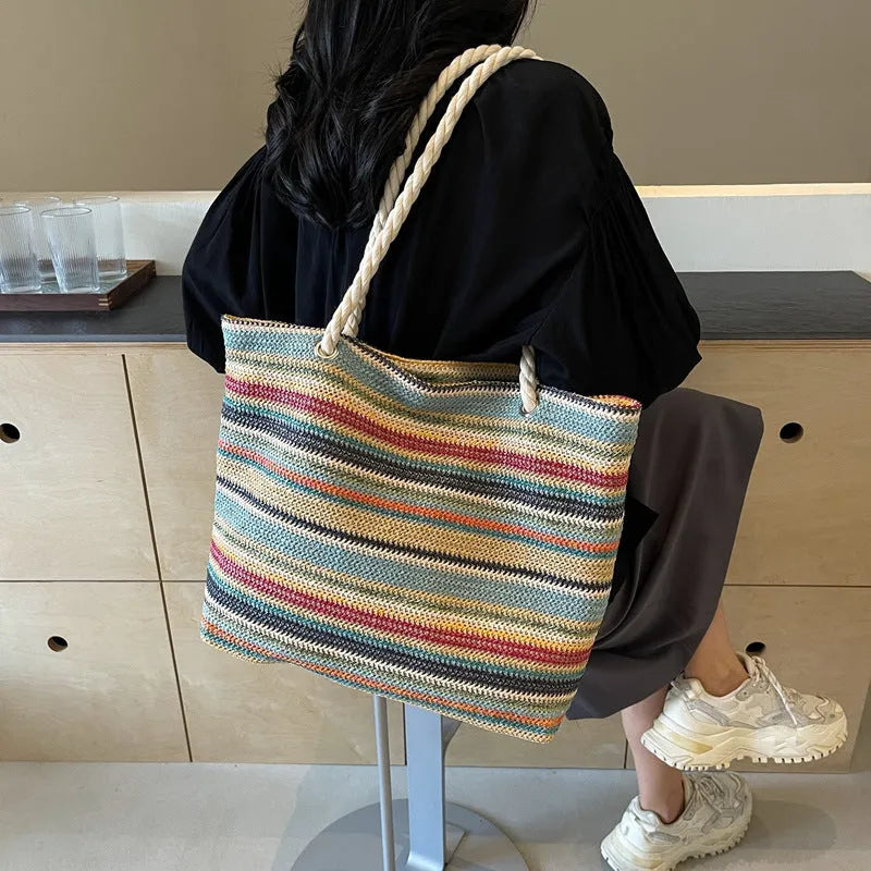Blue woven straw shoulder bag with traditional weaving patterns and single shoulder strap