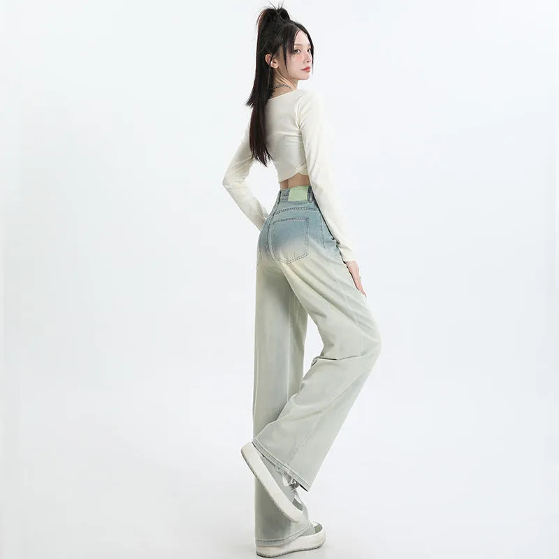 Women's gradient blue straight-leg denim trousers on a model, showing the ombré colour effect.