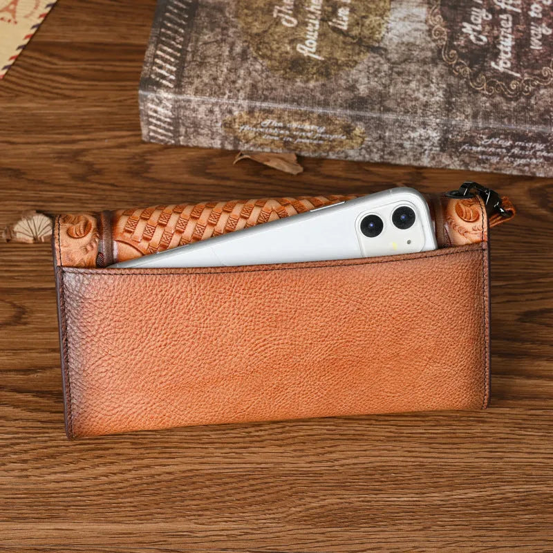 Brown genuine leather tri-fold wallet with embossed floral pattern, shown open to display compartments.