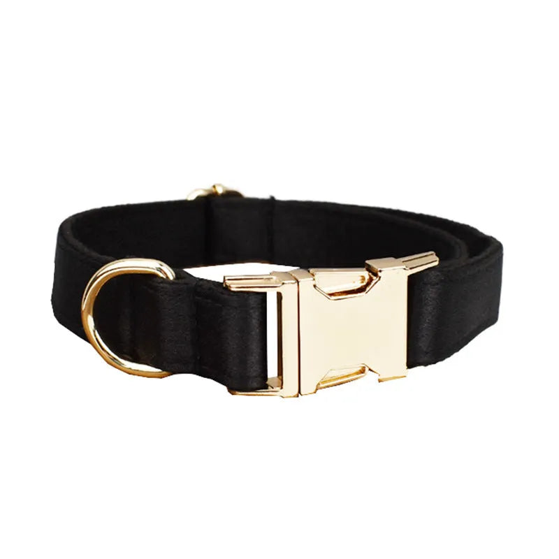A soft cloth dog collar, leash, bow, and matching chest strap set laid out flat, showing coordinated colours.