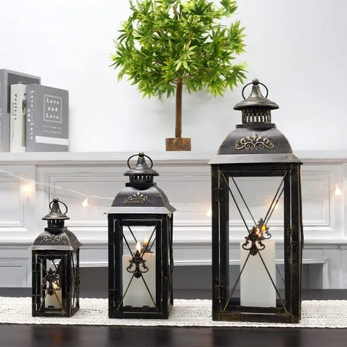 Black and white wrought iron floor-standing storm lantern with tempered glass panels for courtyard use
