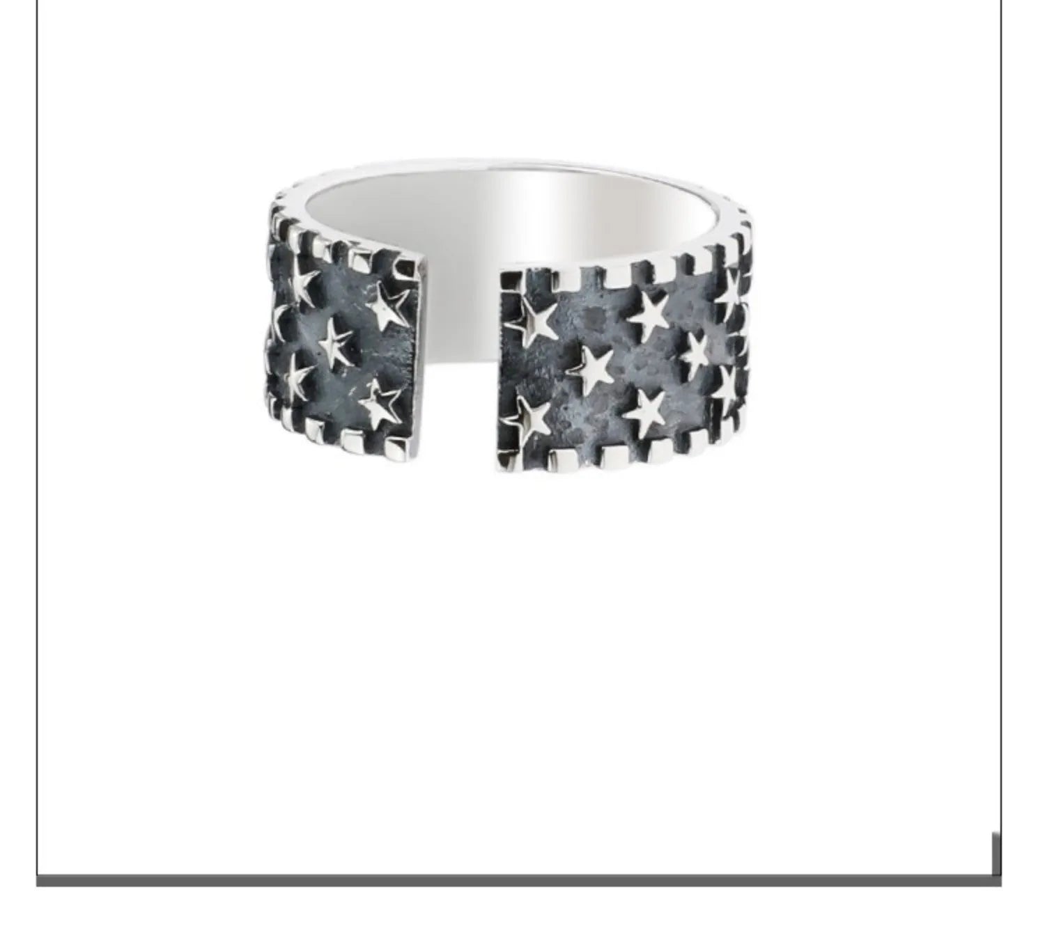 Close-up of a sterling silver ring with a geometric five-pointed star design on an adjustable band.
