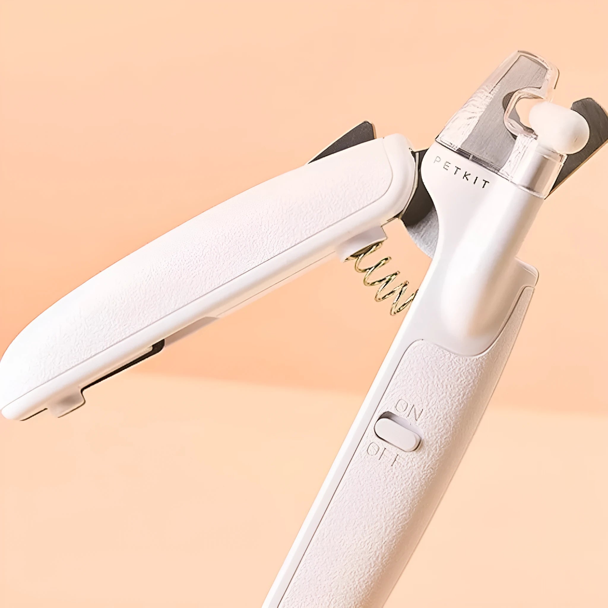 White LED pet nail clippers with open anti-splash guard and nail file on a solid colour background