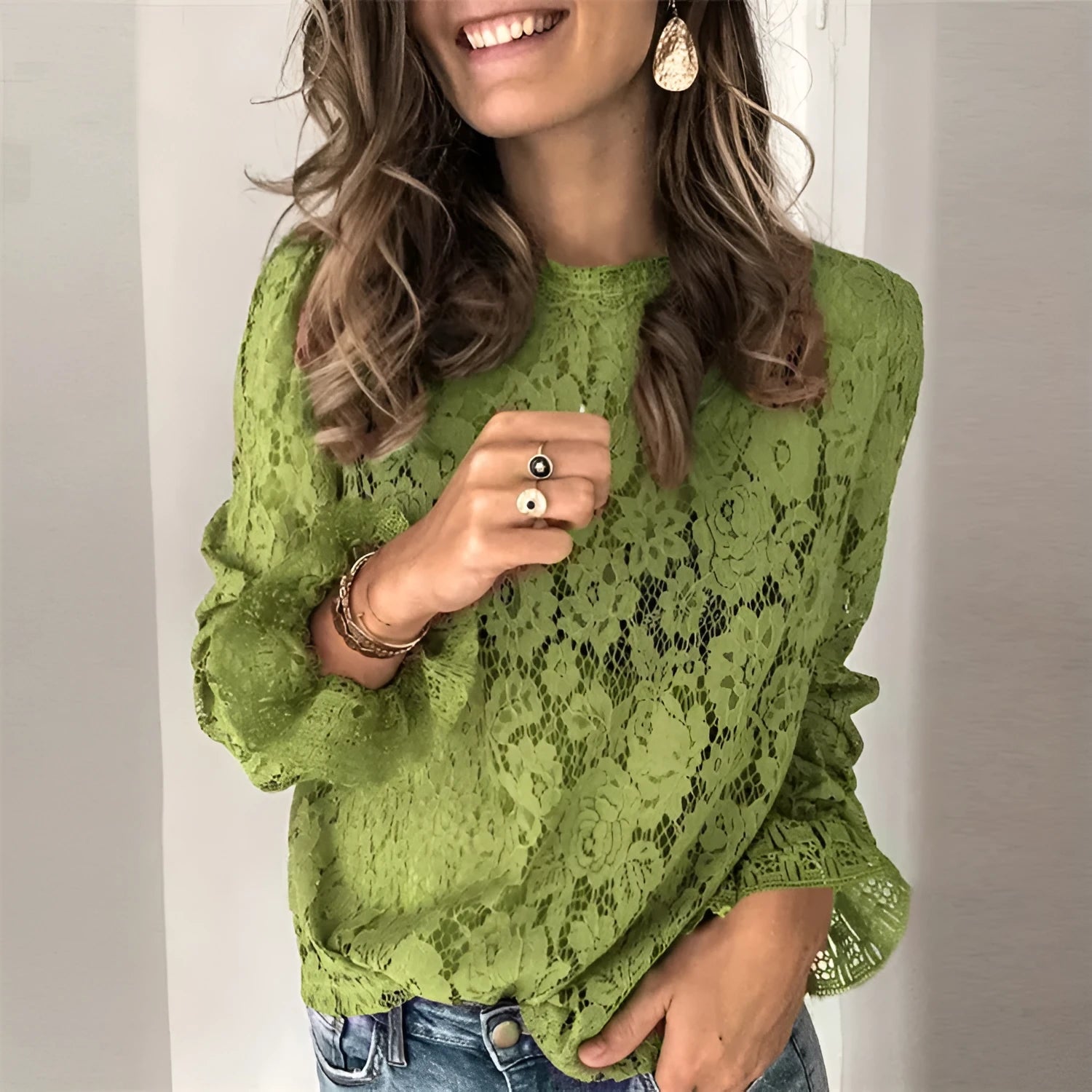 Women's loose-fit hollow lace shirt with round neck, long sleeves, and a zipper detail in a choice of colours.