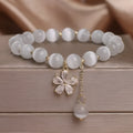 Women's white cat's eye crystal bracelet with flower tassel and morganite safety buckle pendant