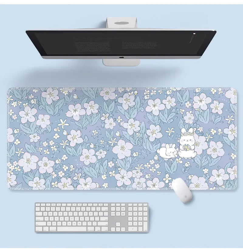 Large flower pattern mouse pad on a desk with keyboard, showing non-slip rubber base and colourful tulip design.