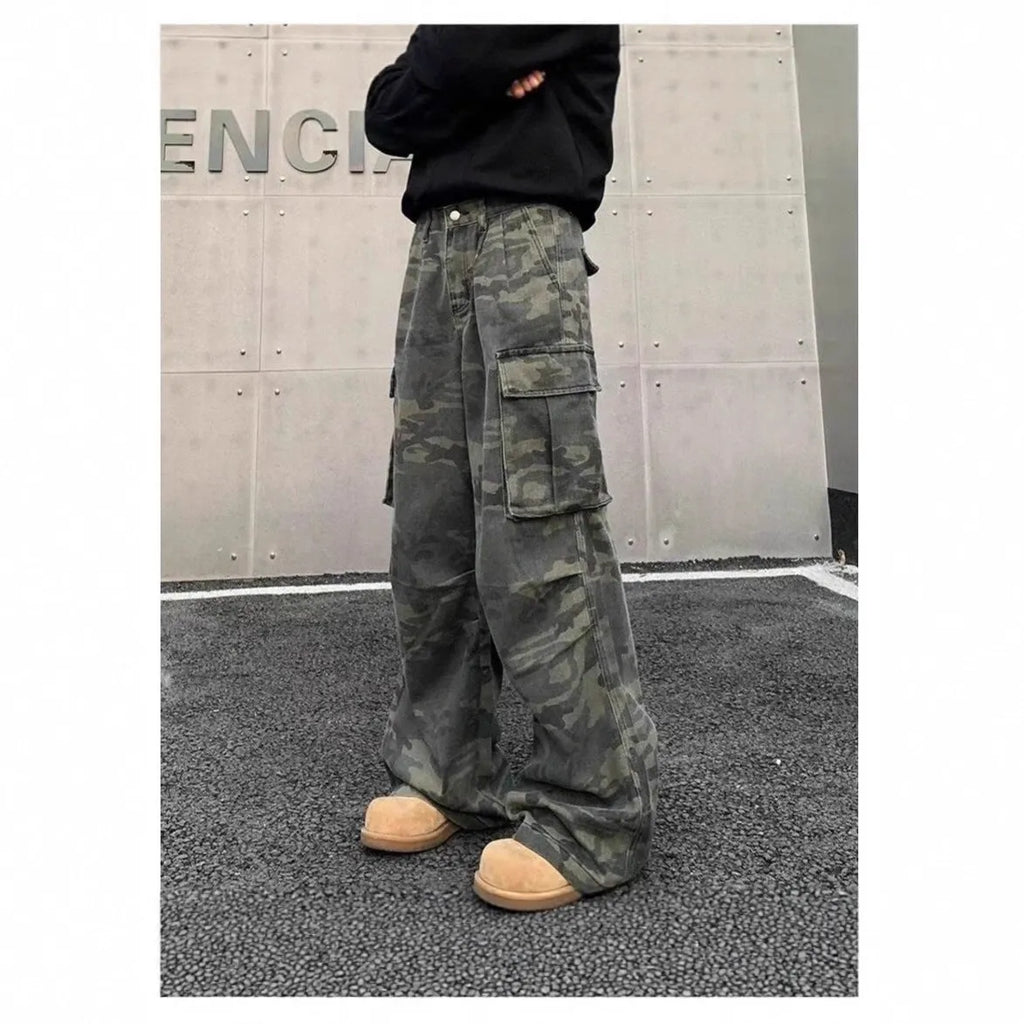 A pair of washed camouflage print cargo pants with multiple pockets on a mid-waist, showing the full trouser length.