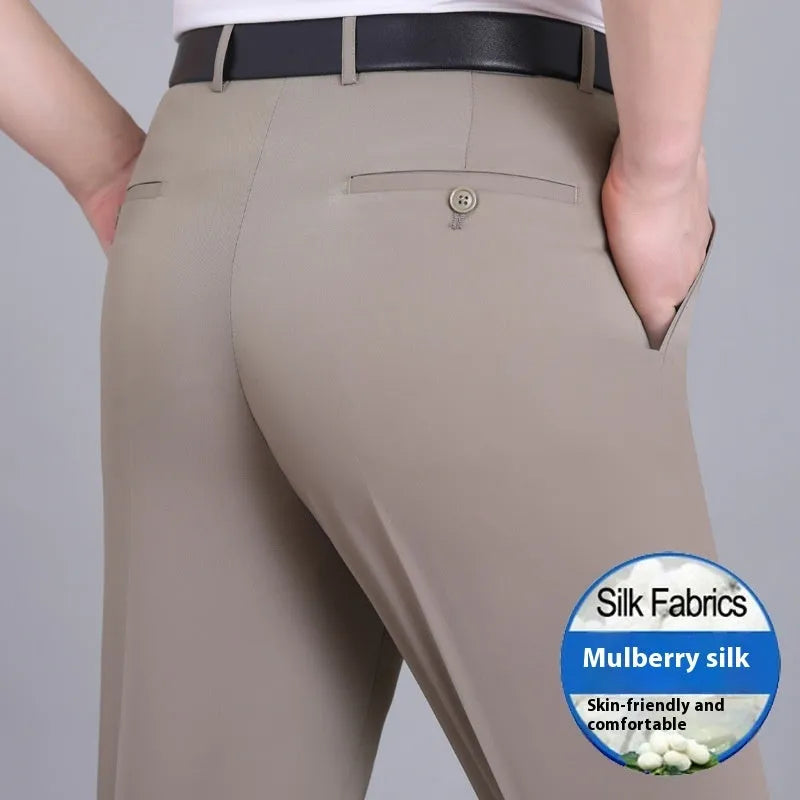 Man wearing black straight-leg high-waisted non-iron business trousers made from a Mulberry Silk blend fabric.