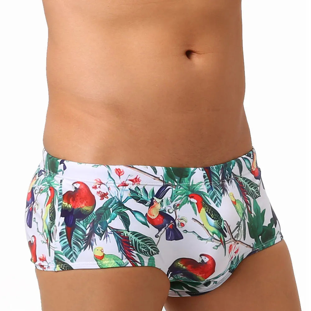 Men's floral and bird print nylon swimming trunks in boxer brief style with cup cover.