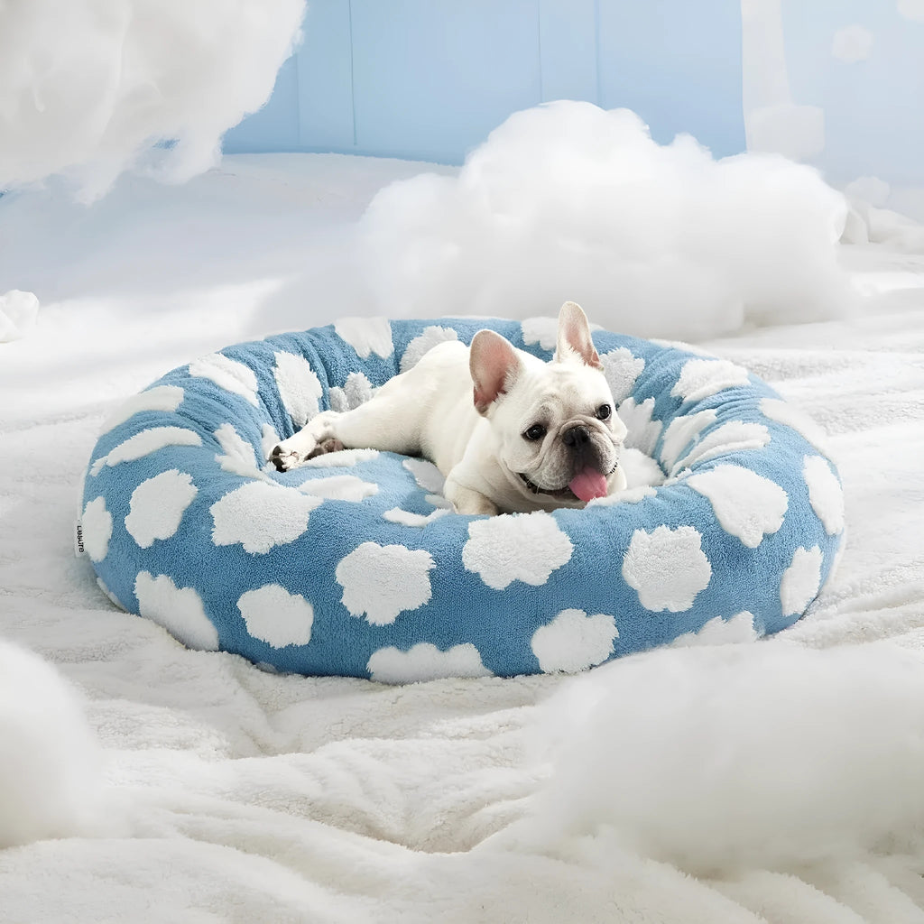 Round blue and white plaid dog bed with a removable cover on a plastic base.