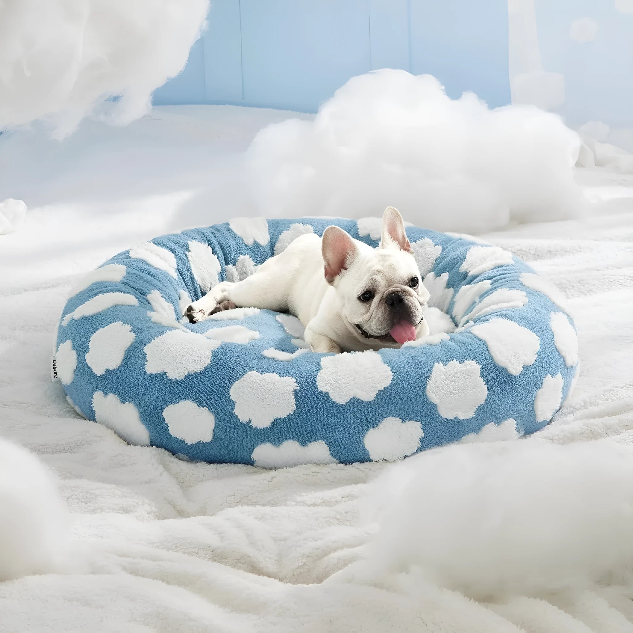 Round blue and white plaid dog bed with a removable cover on a plastic base.