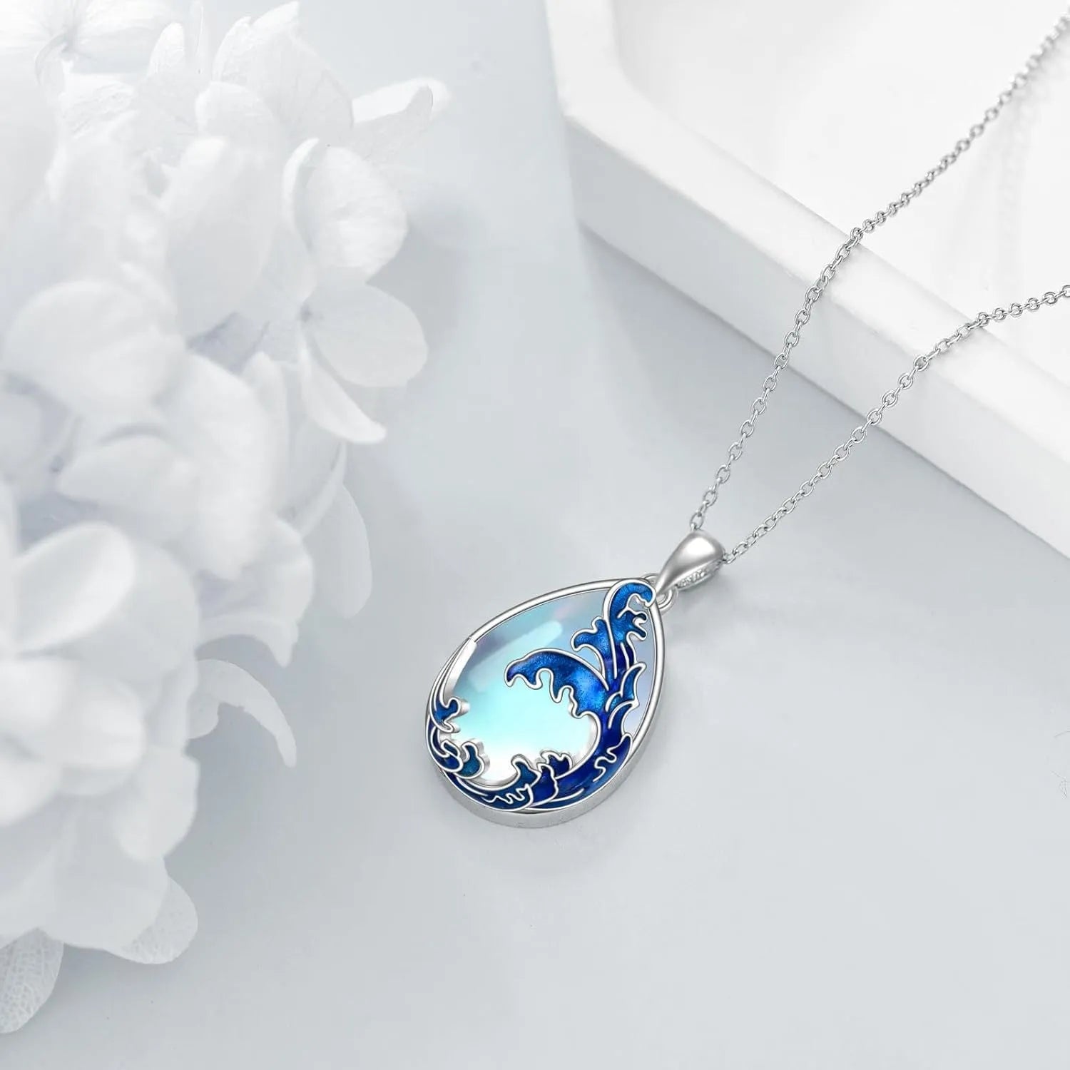 Blue heart-shaped pendant necklace with alloy chain on display