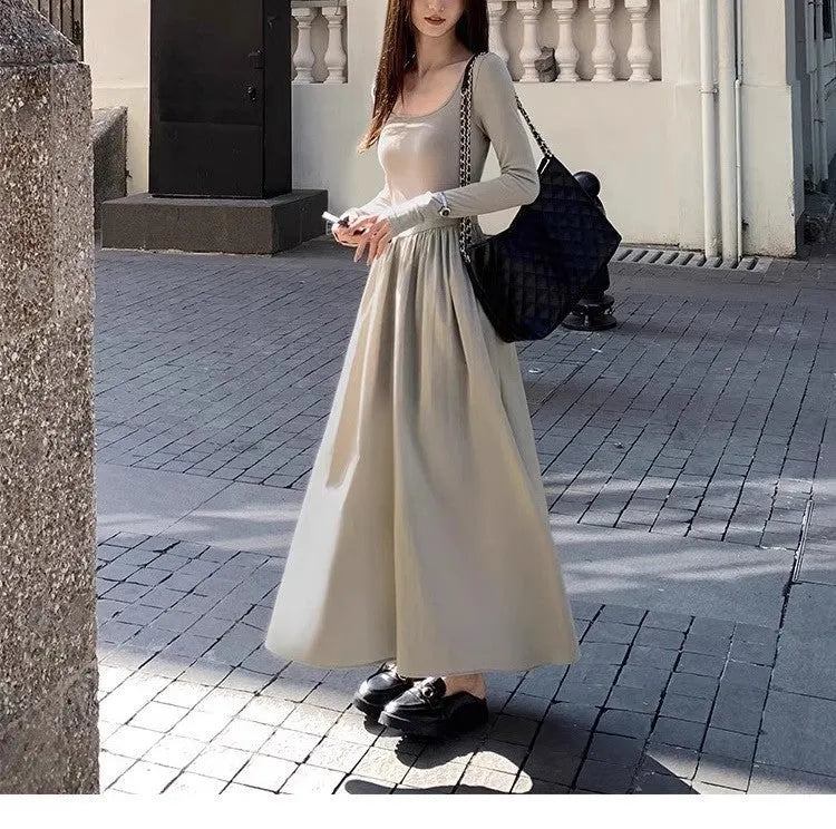 Women's black knitted dress with square collar and elastic waistband showing A-line long skirt design