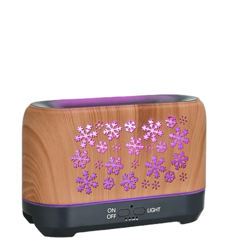 Christmas snowflake pattern humidifier with colourful flame effects and remote control on wooden desk