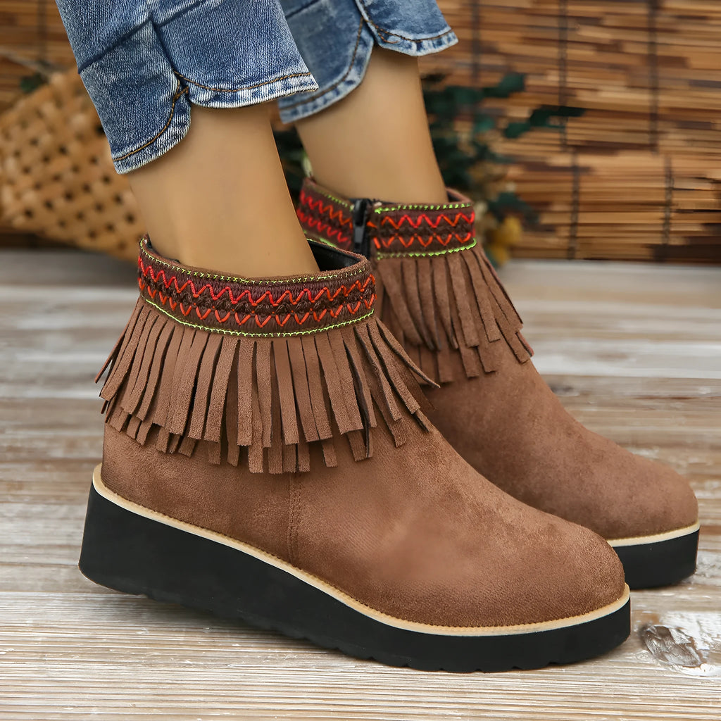 Womens dark brown suede wedge ankle boots with side zip and tassel detail on a thick rubber sole.