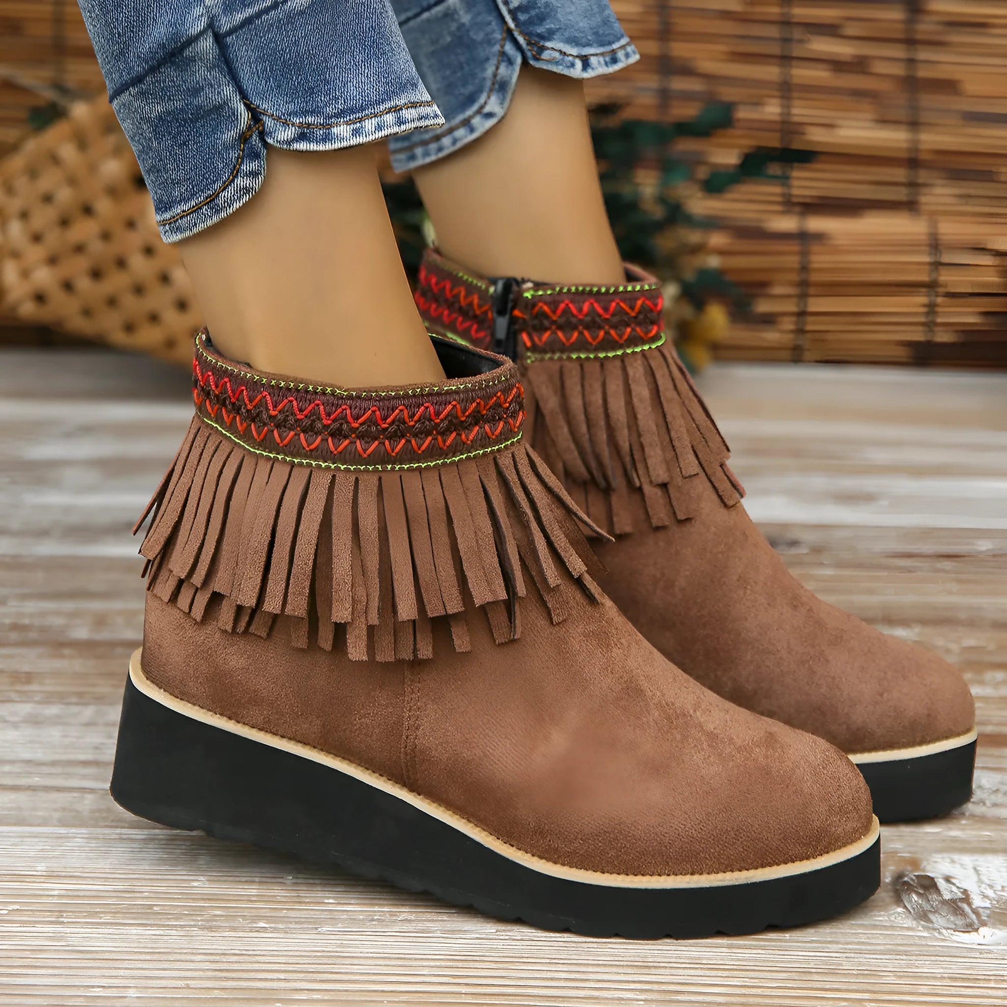Womens dark brown suede wedge ankle boots with side zip and tassel detail on a thick rubber sole.