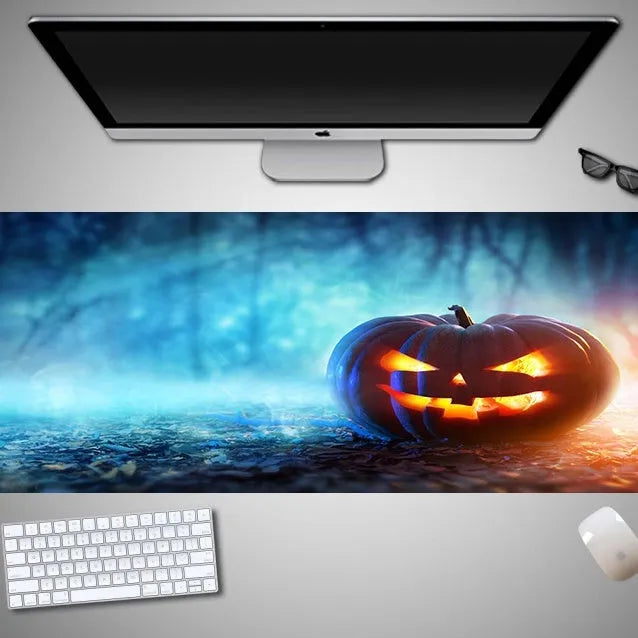Oversized Halloween-themed computer mouse pad with non-slip rubber cloth base on a desk