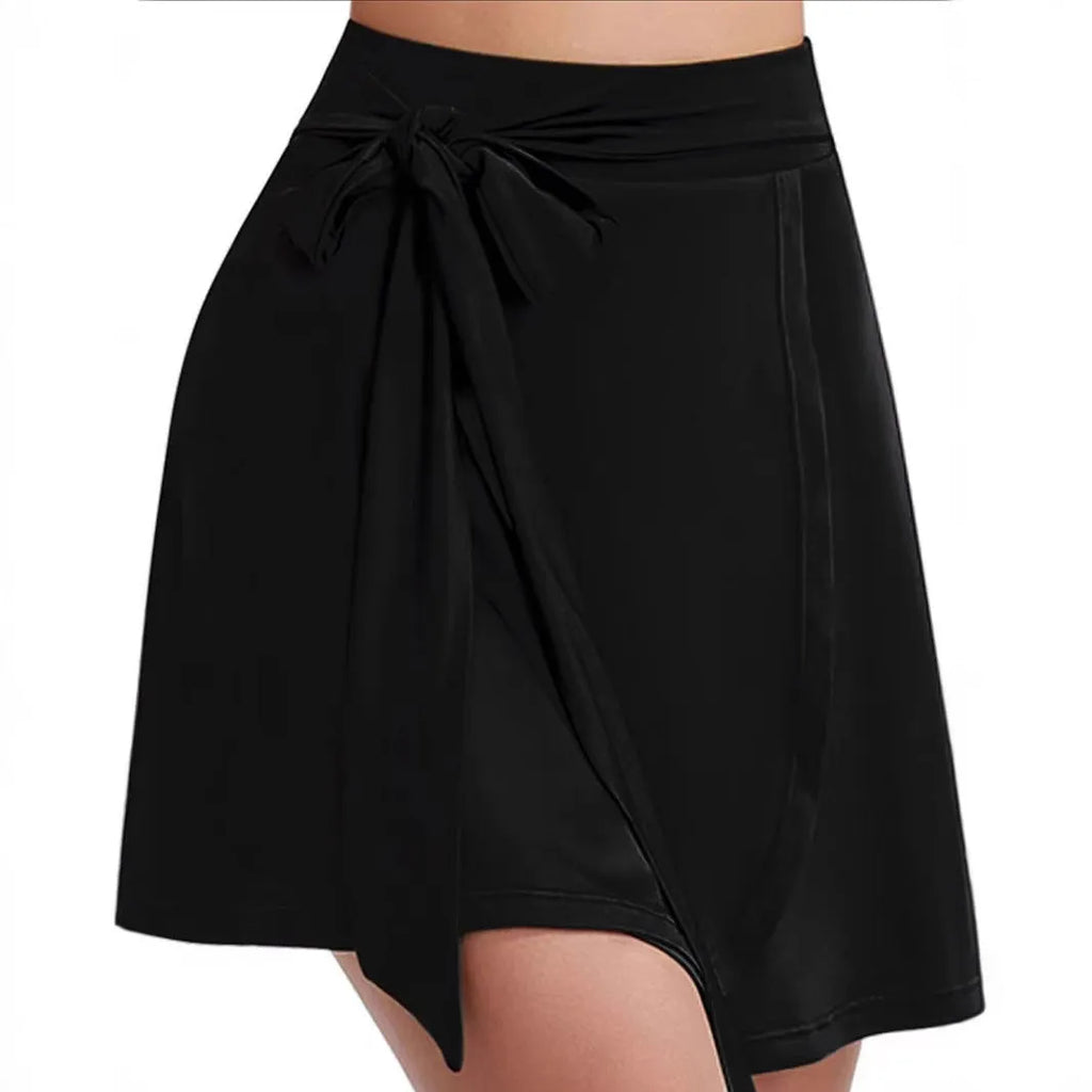 Black thigh-length unisex sports skirt with high waist and built-in shorts, laid flat.