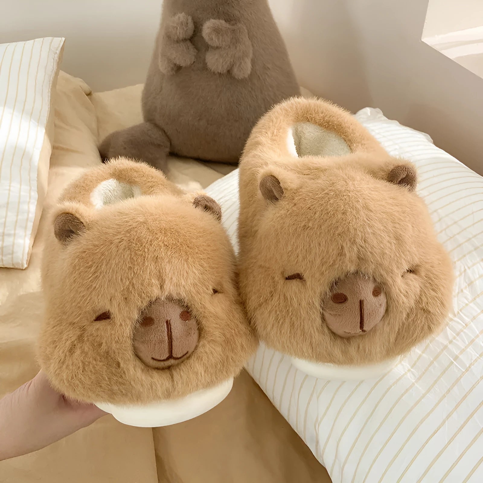 Light brown women's plush winter slippers with a round toe and slip-on design on a white background.