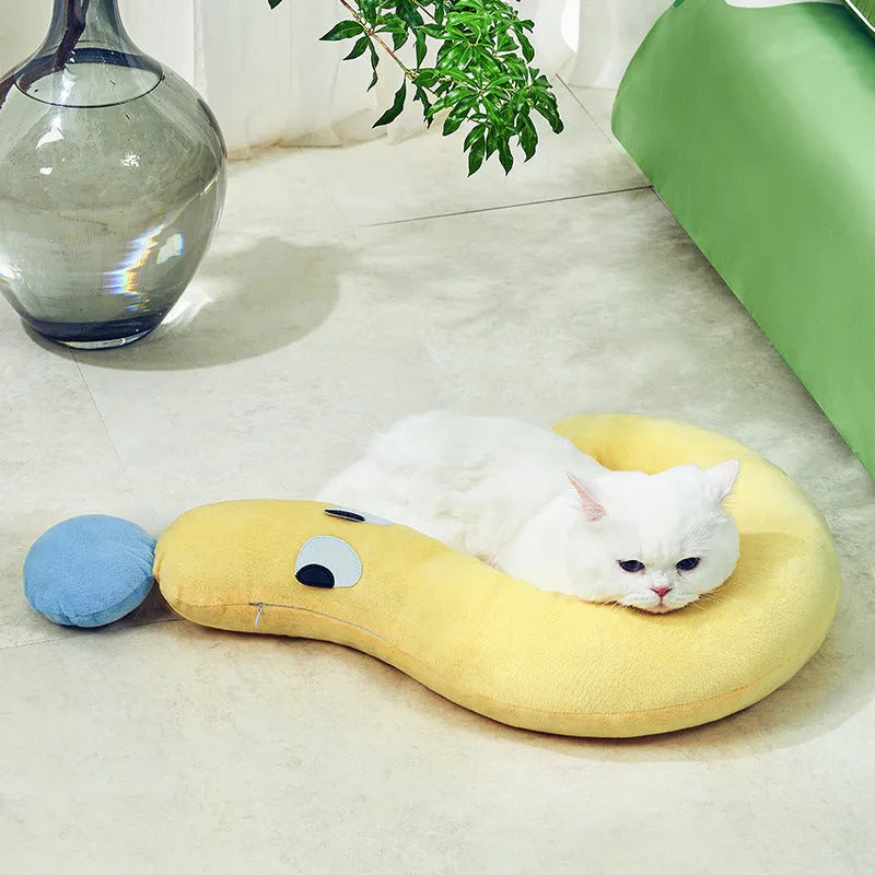Blue or yellow rectangular pet sleeping pillow measuring 62cm by 39cm on a floor.