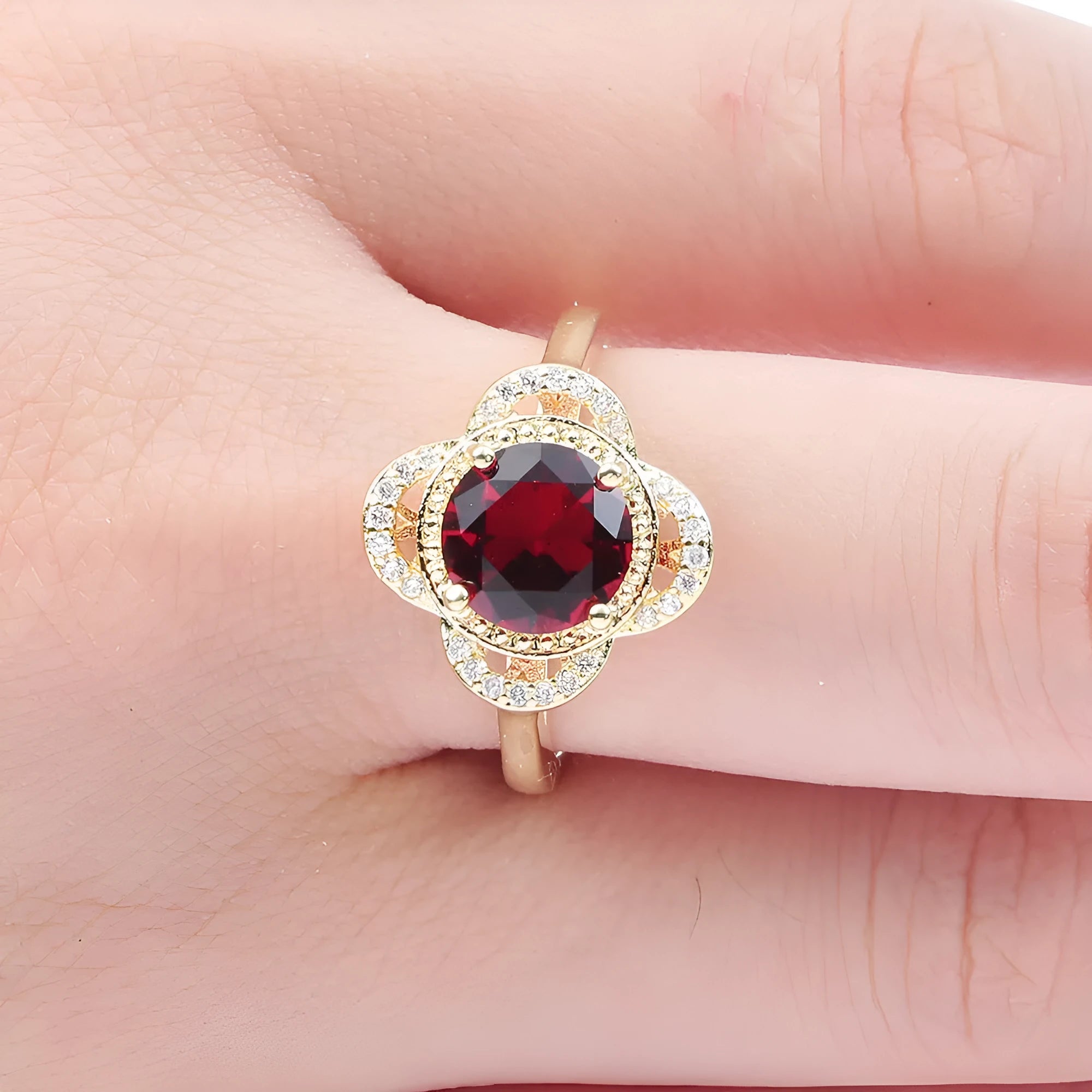 Copper fruit-shaped ring with zircon inlay in electroplated 10-6-1395 colour on a finger.