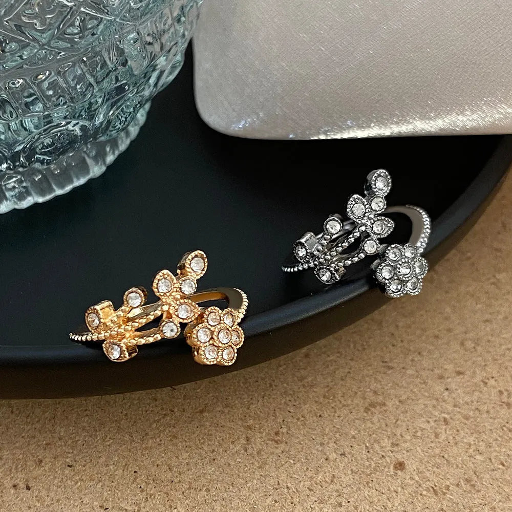 Women's copper floral open ring with diamond finish showing gold and white colour options