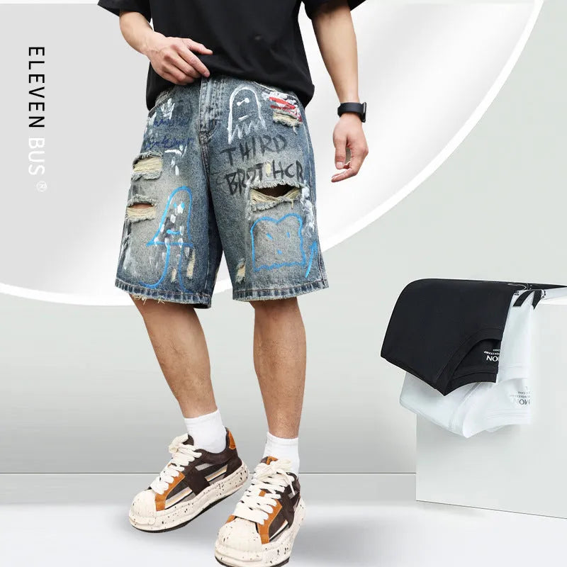 Blue ripped men's denim shorts with graffiti detail and a straight leg.