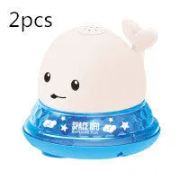 White and blue whale-shaped bath toy with water spray and LED lights floating in water