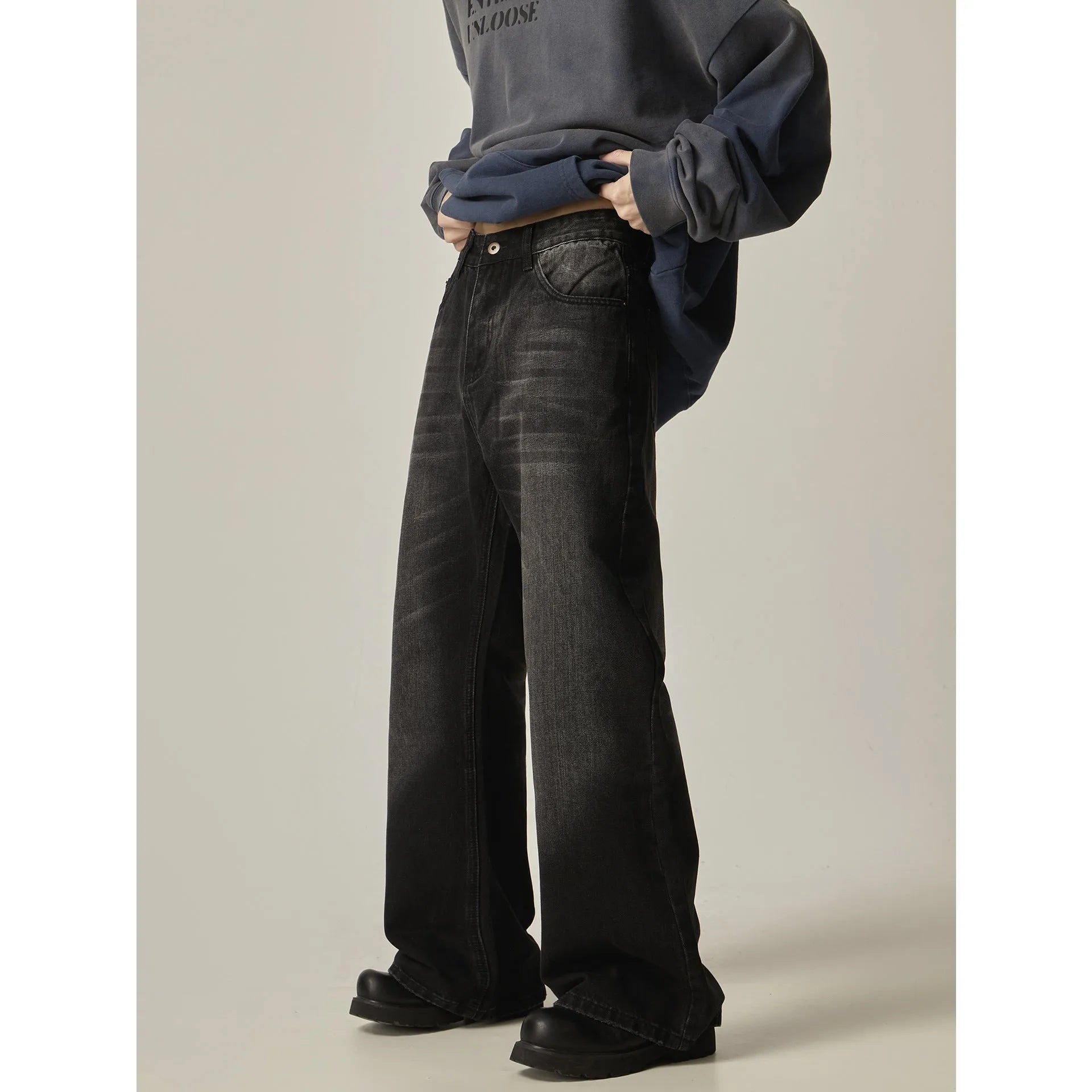 Black loose-fit straight-leg retro jeans on a mannequin, showing zip fly and casual style.
