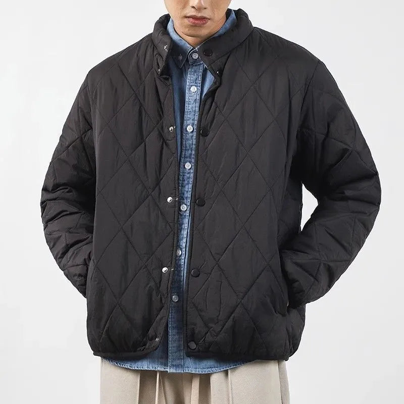 Men's black extended length winter jacket showing loose fit and urban style design