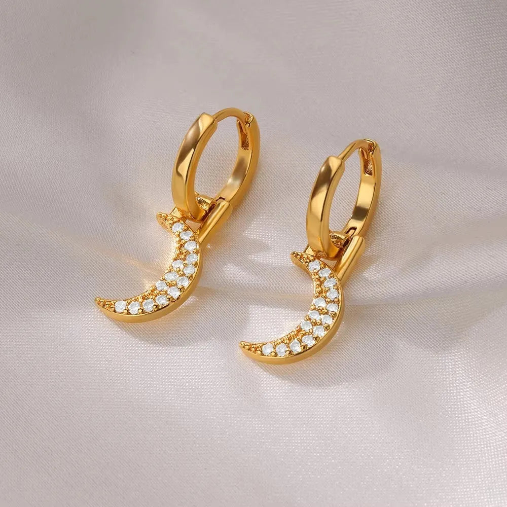 Geometric butterfly-shaped earrings with heart, bow, and star details in copper with a diamond-cut finish.