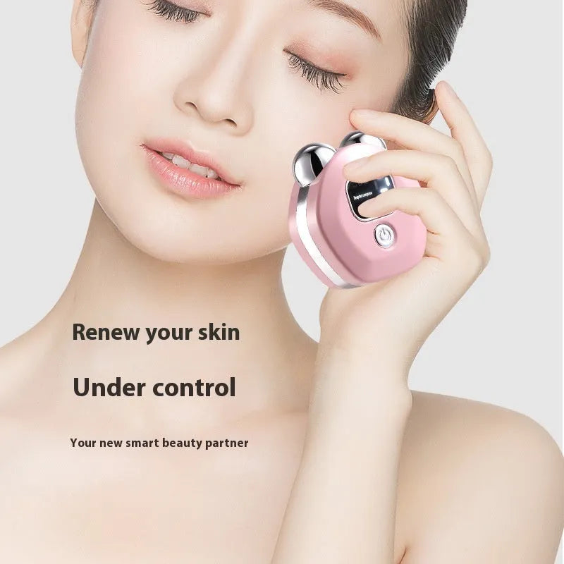 Portable white facial massage instrument with double-roller head for hot compress and microcurrent treatment.