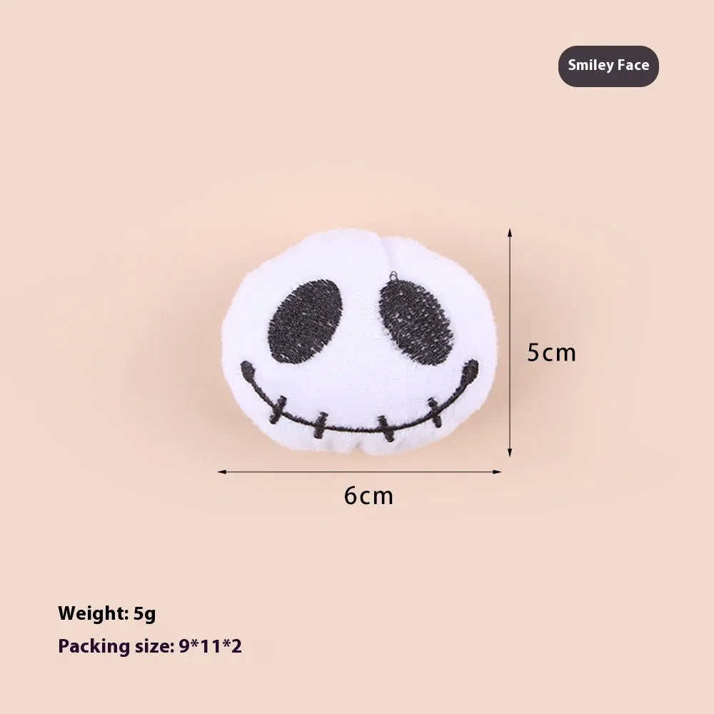 Small plush cat teaser toy with candy, eyes and skull attachments on lightweight handle