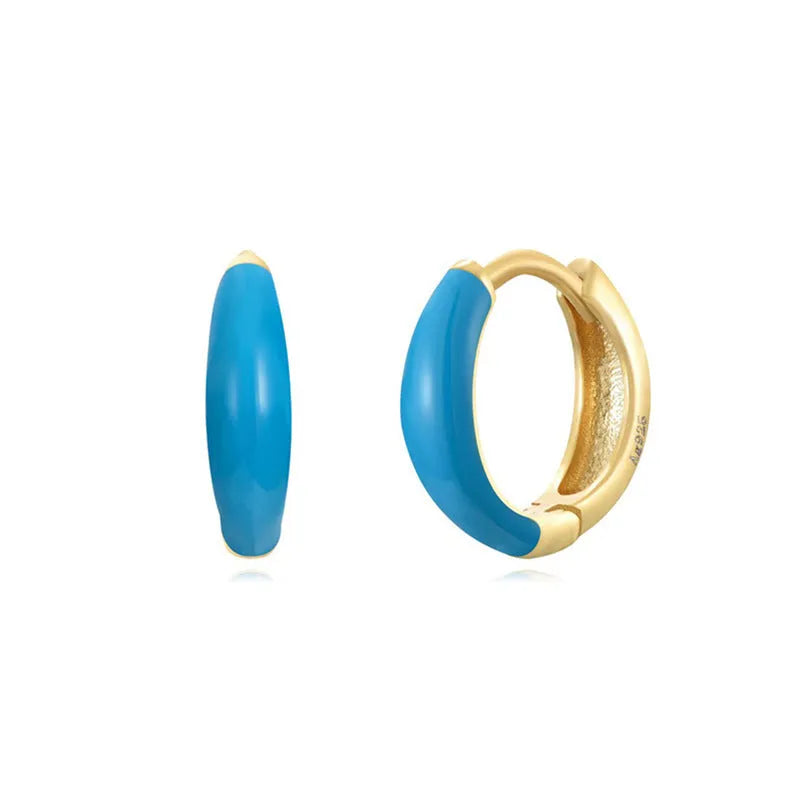Geometric U-shaped oval epoxy earrings in dripped oil colours on copper wire.